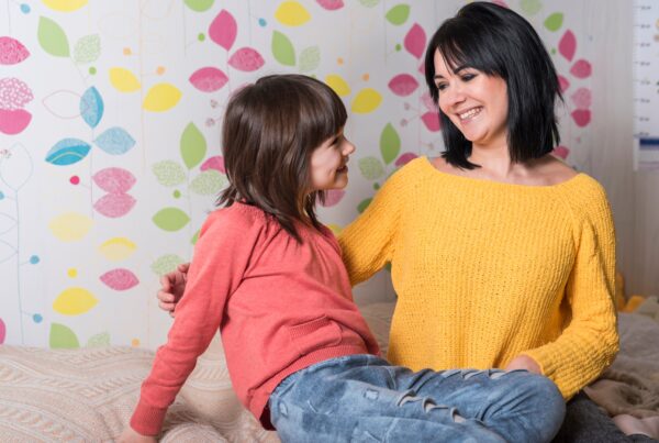 happy mother daughter sitting bed 1