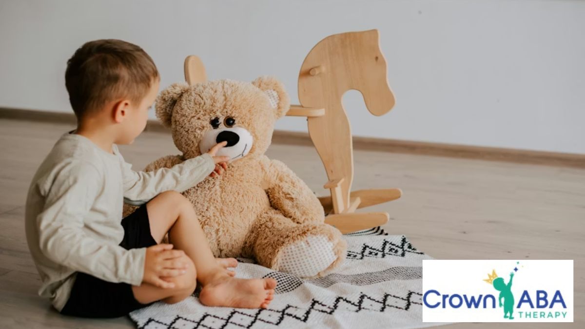 A young child practicing social skills independently during ABA therapy on the living room floor.