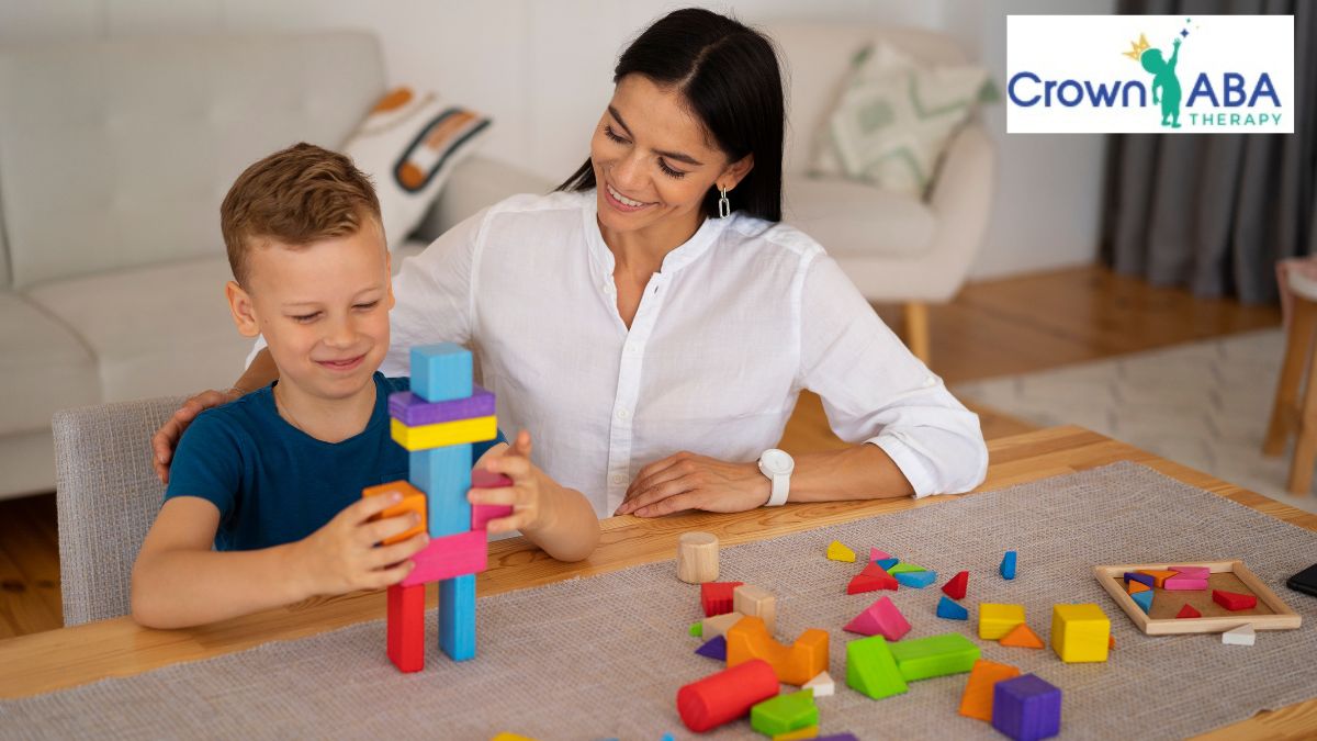 Early intervention autism: a boy receives instruction from a therapist during a play activity with blocks and puzzles.