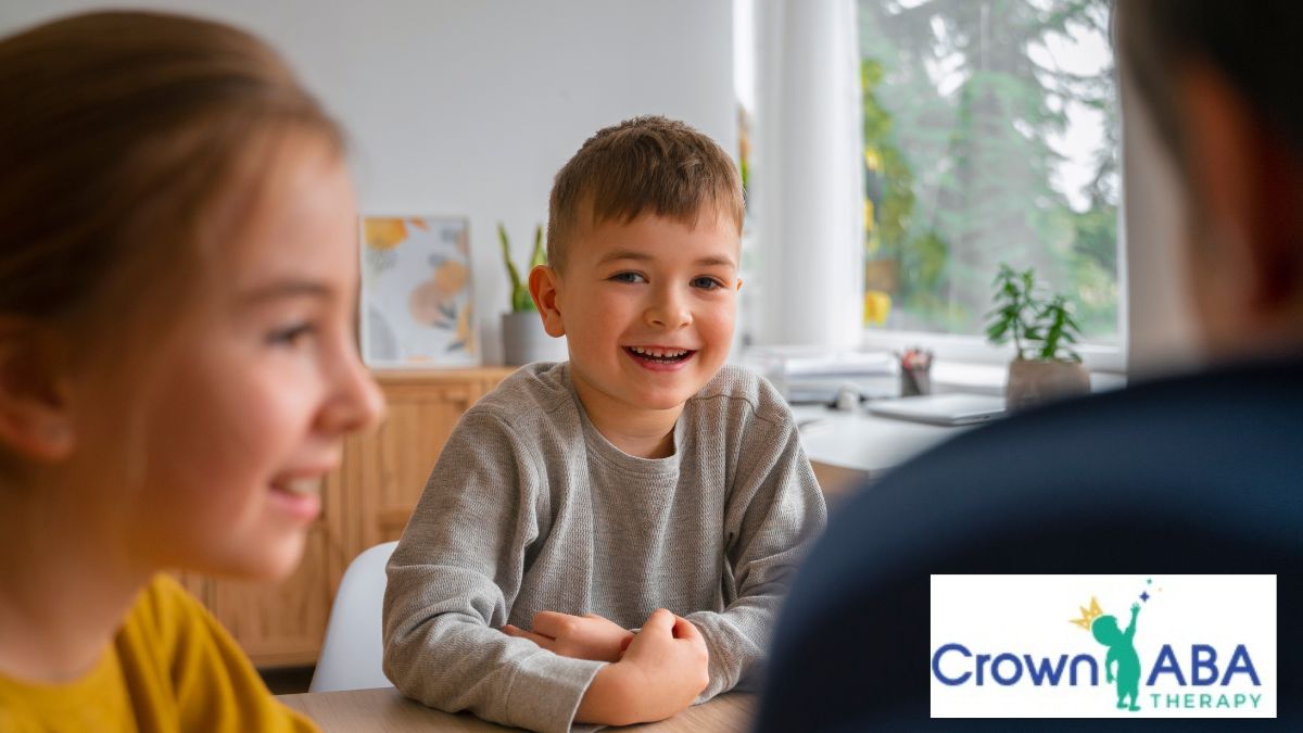 Children practice ABA communication skills during a pleasant family gathering in the kitchen.