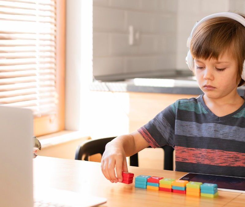 Early intervention autism: a boy completes an ABA activity in a home office setting.