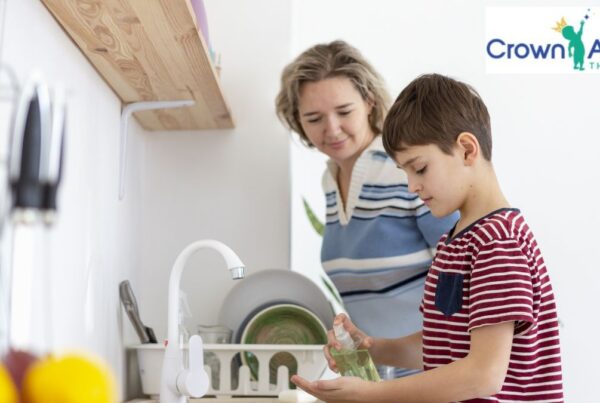 ABA therapy in Maryland: a young child completes kitchen chores while a parent looks on.