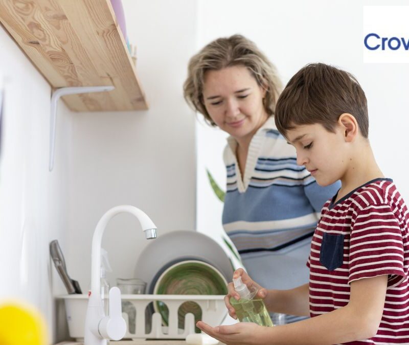 ABA therapy in Maryland: a young child completes kitchen chores while a parent looks on.